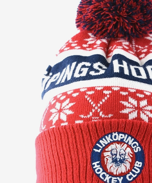Stickad snöflingetröja i blått, vitt och rött med Linköping Hockey Clubs logotyp